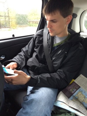 Mark consulting his GPS and comparing it to the maps.